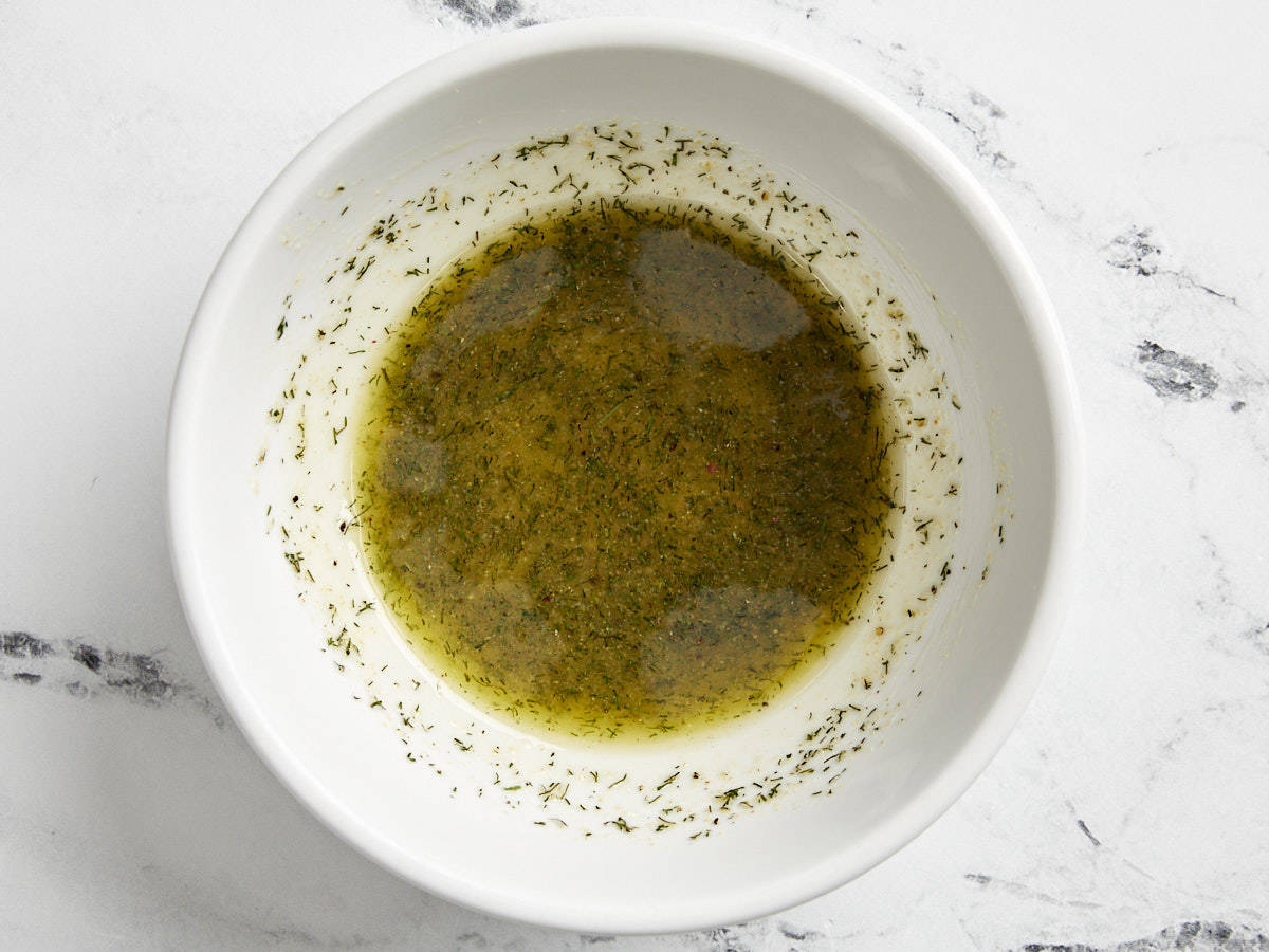 Butter, oil, and seasoning mixed together in a bowl.