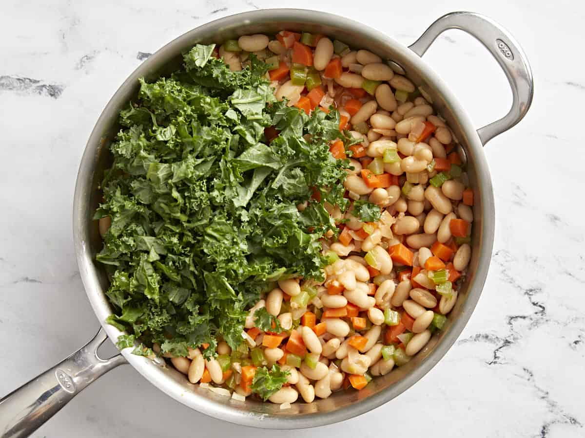 Add the kale to the buffalo beans in a skillet.