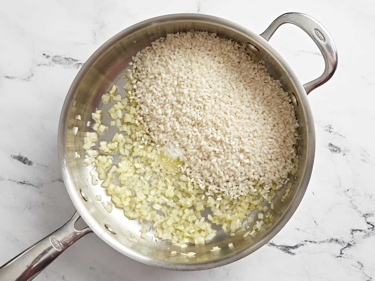 diced onion and rice in a pan.