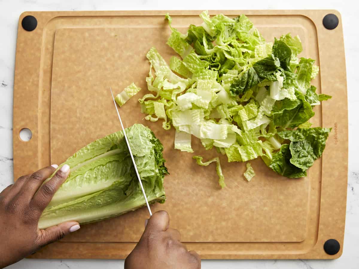 Chopped romaine lettuce on a cutting board.