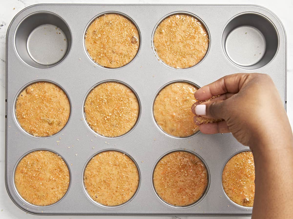 Turbinado sugar being added to Carrot Cake Muffins