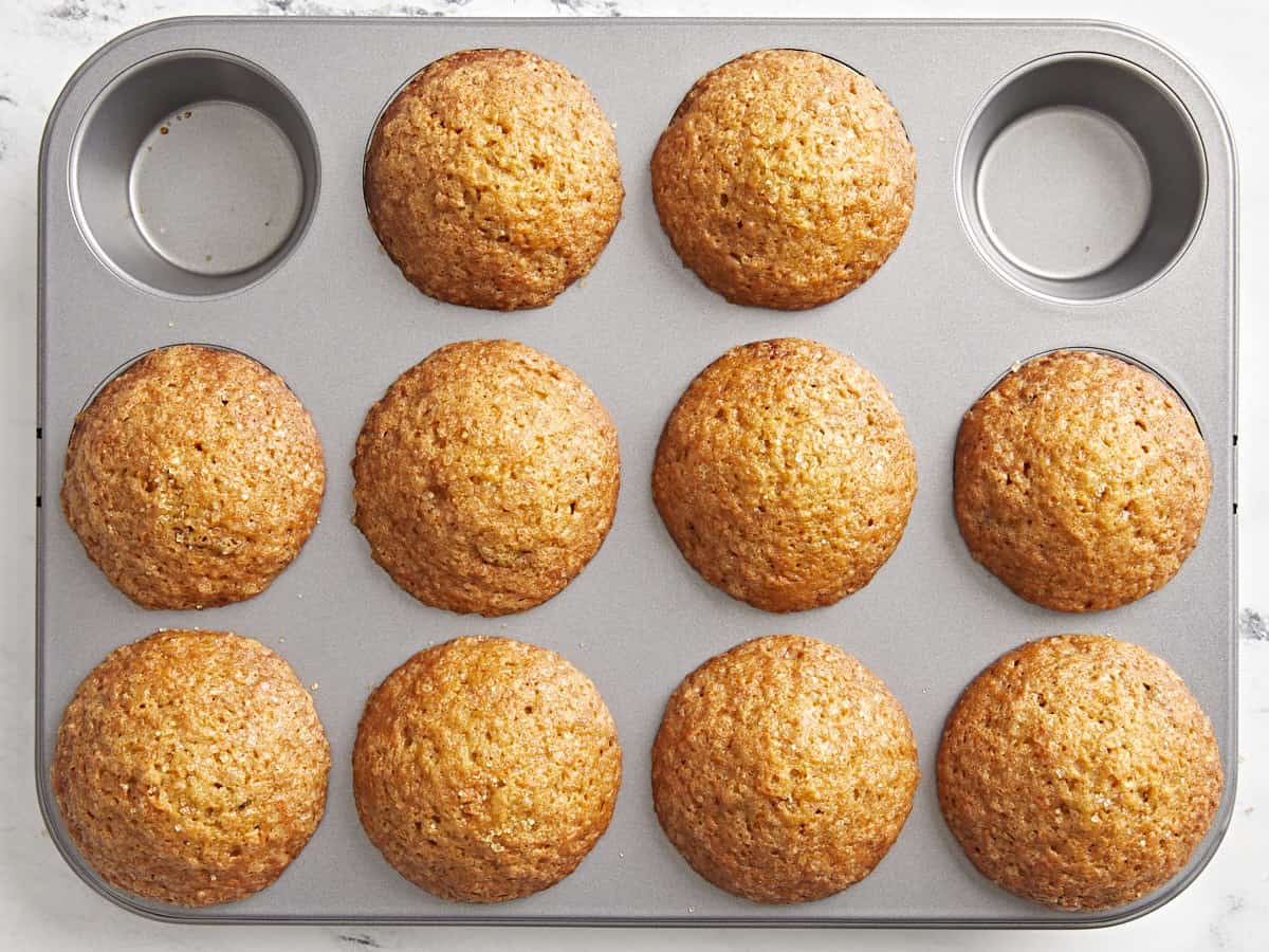 Top view of cooked carrot cake muffins in a muffin tin.