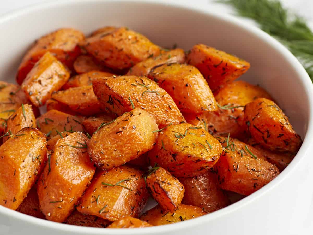 Close-up of Air Fryer carrots in a white serving dish.