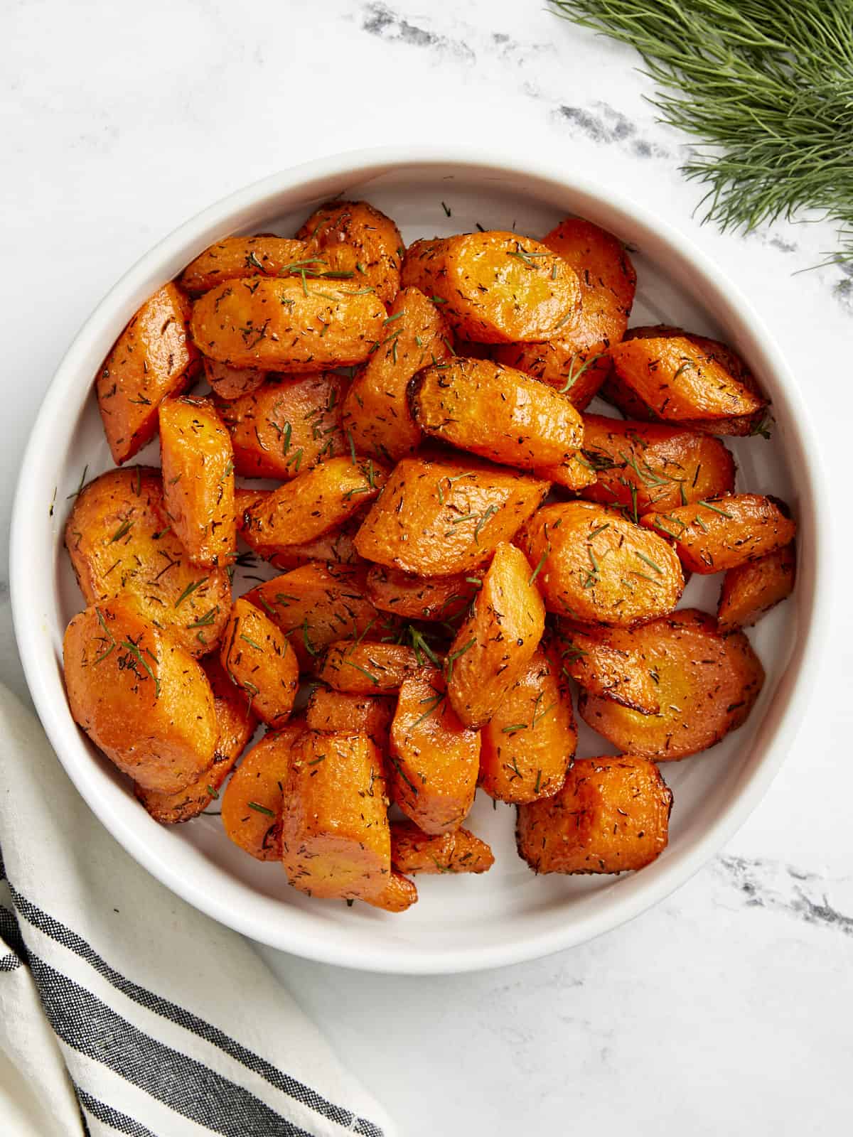 Top view of air fryer carrots in a white serving dish.