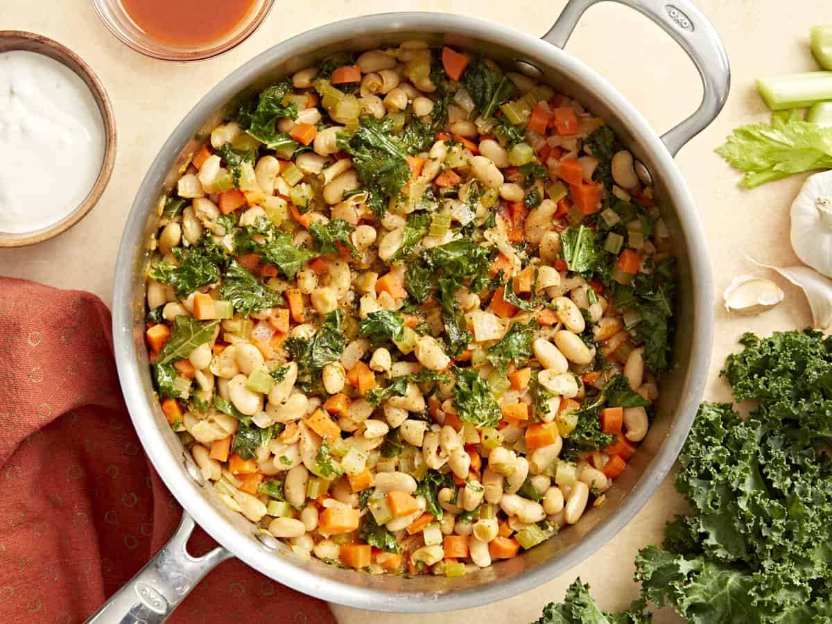 Top view of buffalo beans and vegetables in a pan.