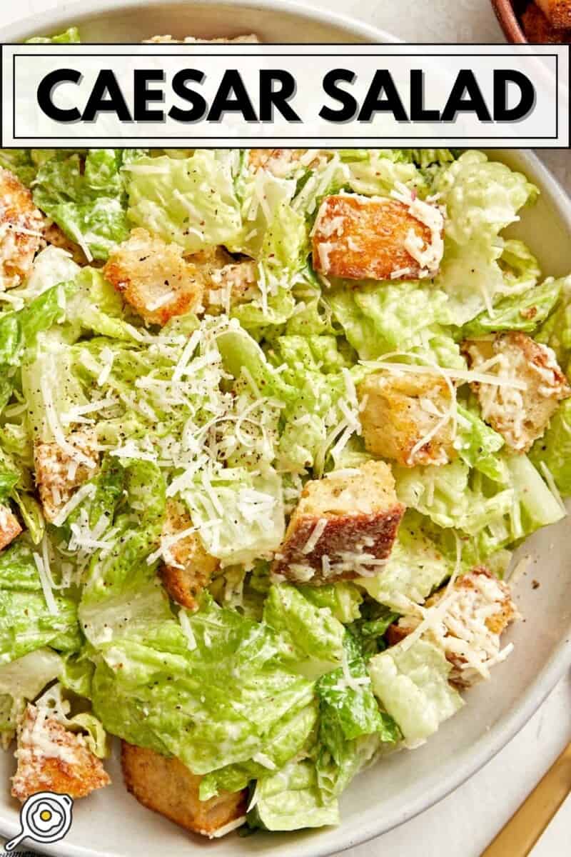 Overhead view of a plate of caesar salad with a gold fork on the side and title text at the top.