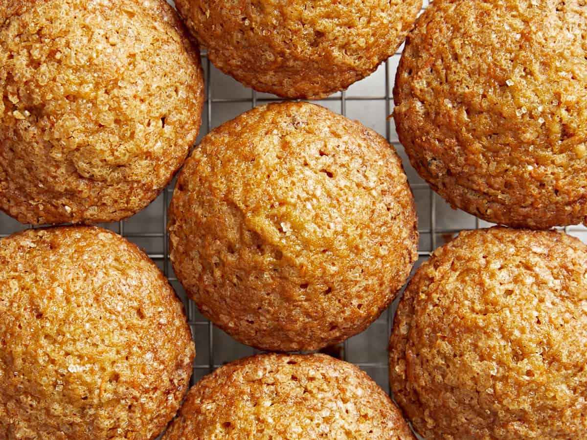 Top view: carrot cake muffins close together on a cooling rack.