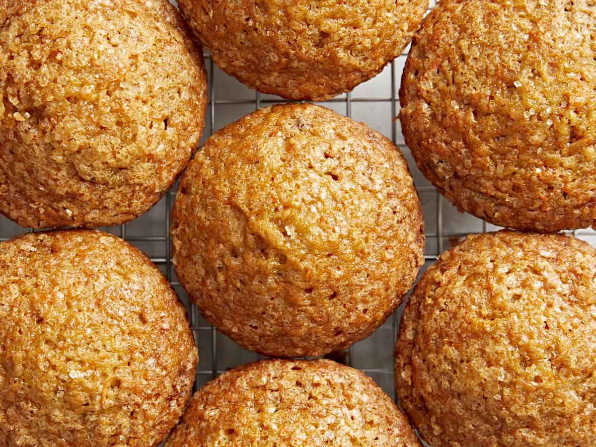 Overhead view of carrot cake muffins close together on a cooling rack.