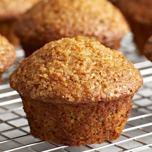 Close-up of carrot cake muffins on a cooling rack.