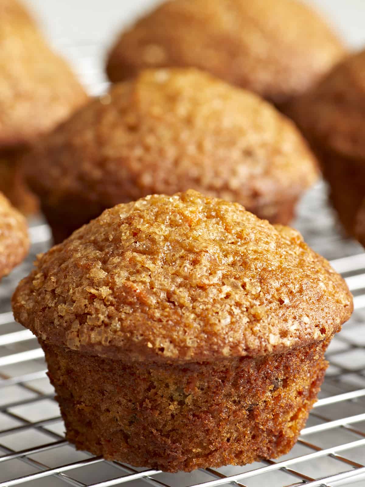 Close-up of carrot cake muffins on a cooling rack.