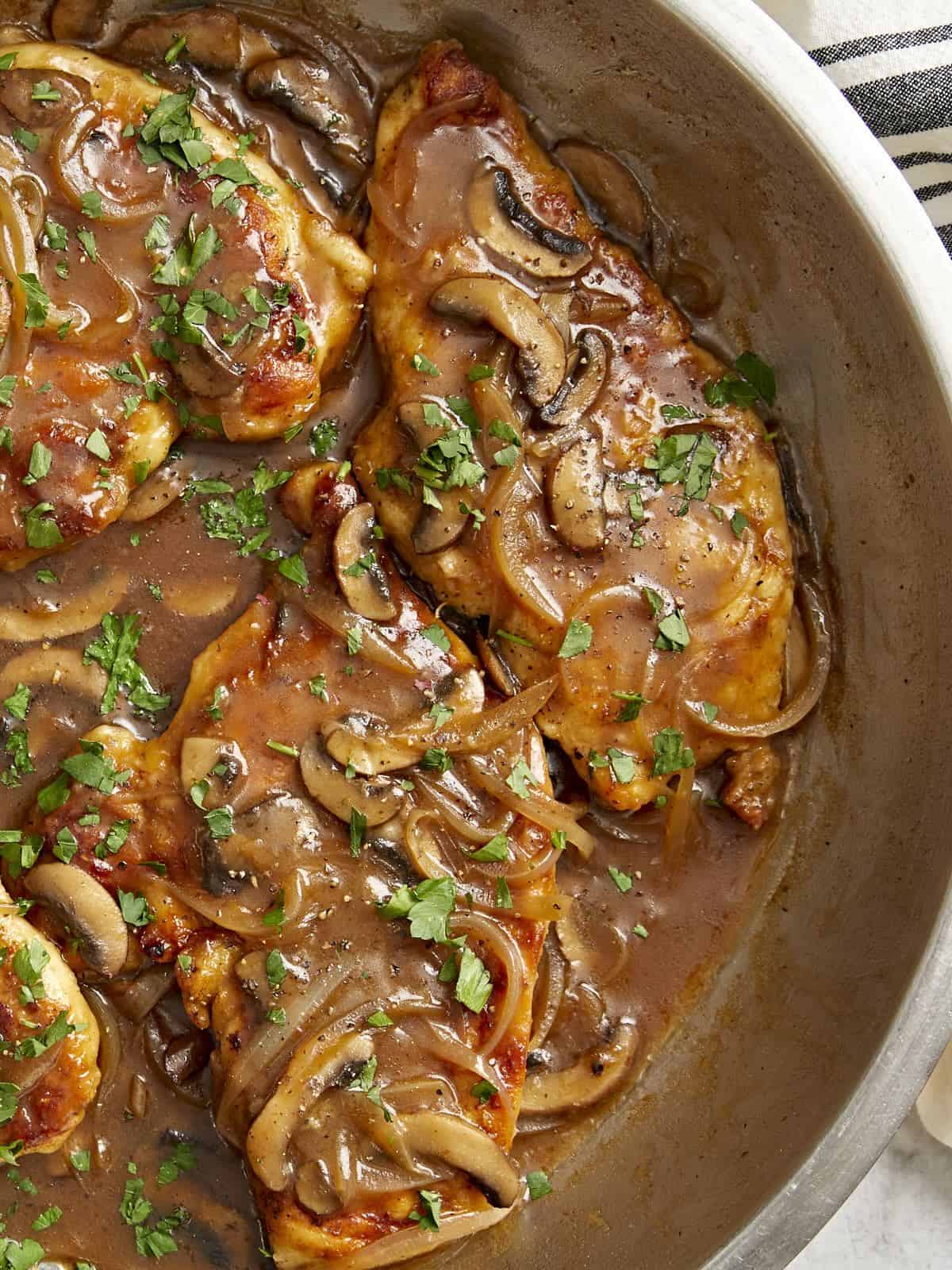 partial overhead view of chicken marsala in a pan.