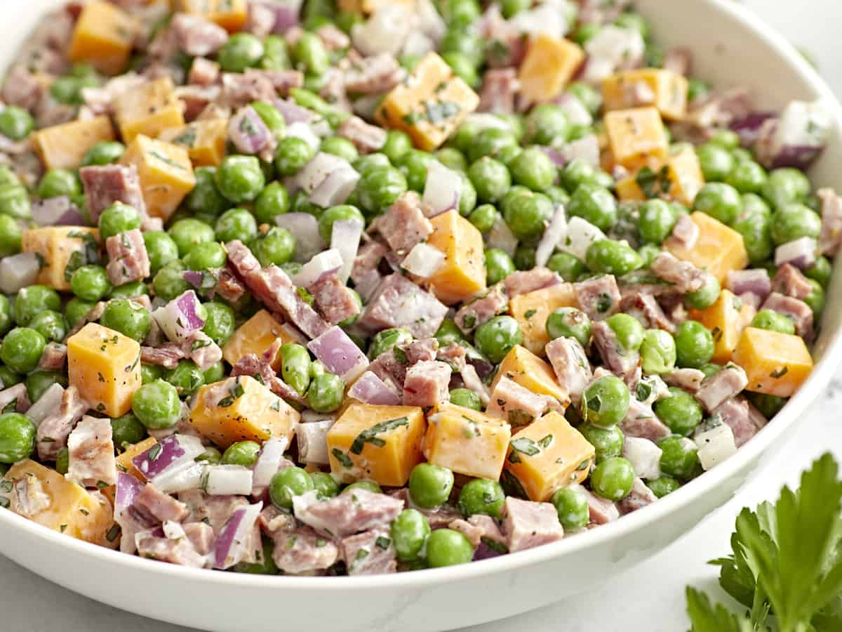 pea salad in a white bowl.