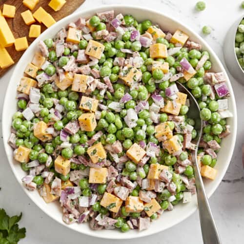 overhead view of pea salad with a spoon.