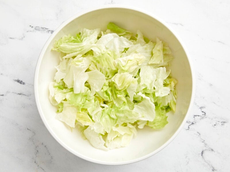 chopped lettuce in a white bowl.
