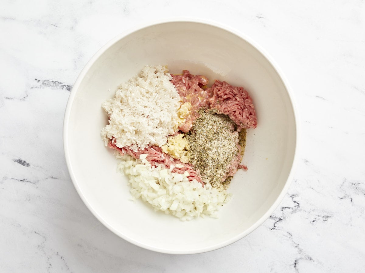 Place meat and porcupine meatball ingredients in a large bowl.