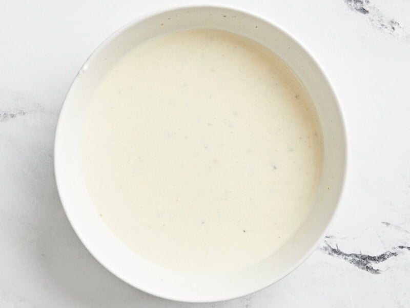creamy dressing in a white bowl.