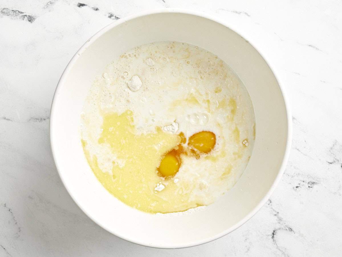 Dry and wet ingredients in a bowl for sheet pan pancakes.