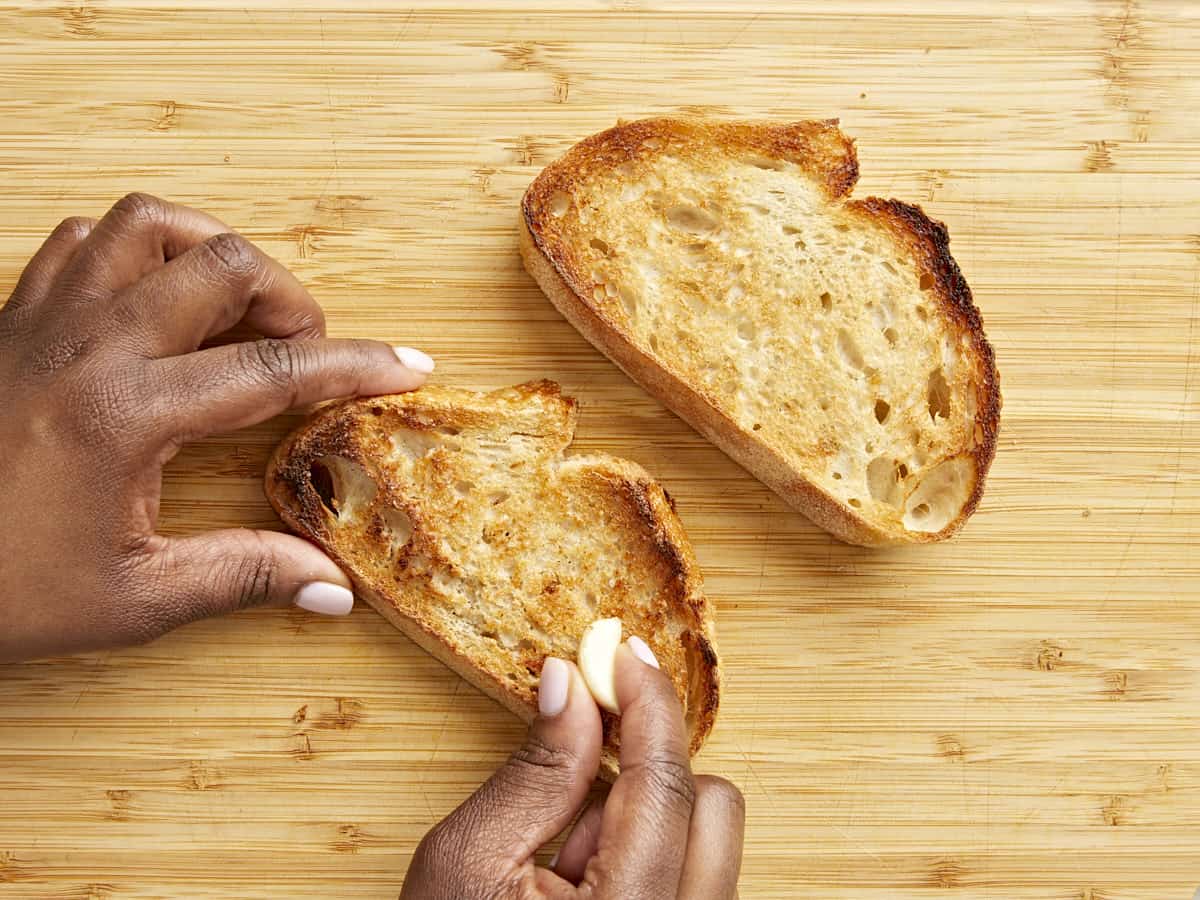 Toasted sourdough bread with a clove of garlic grated on top.