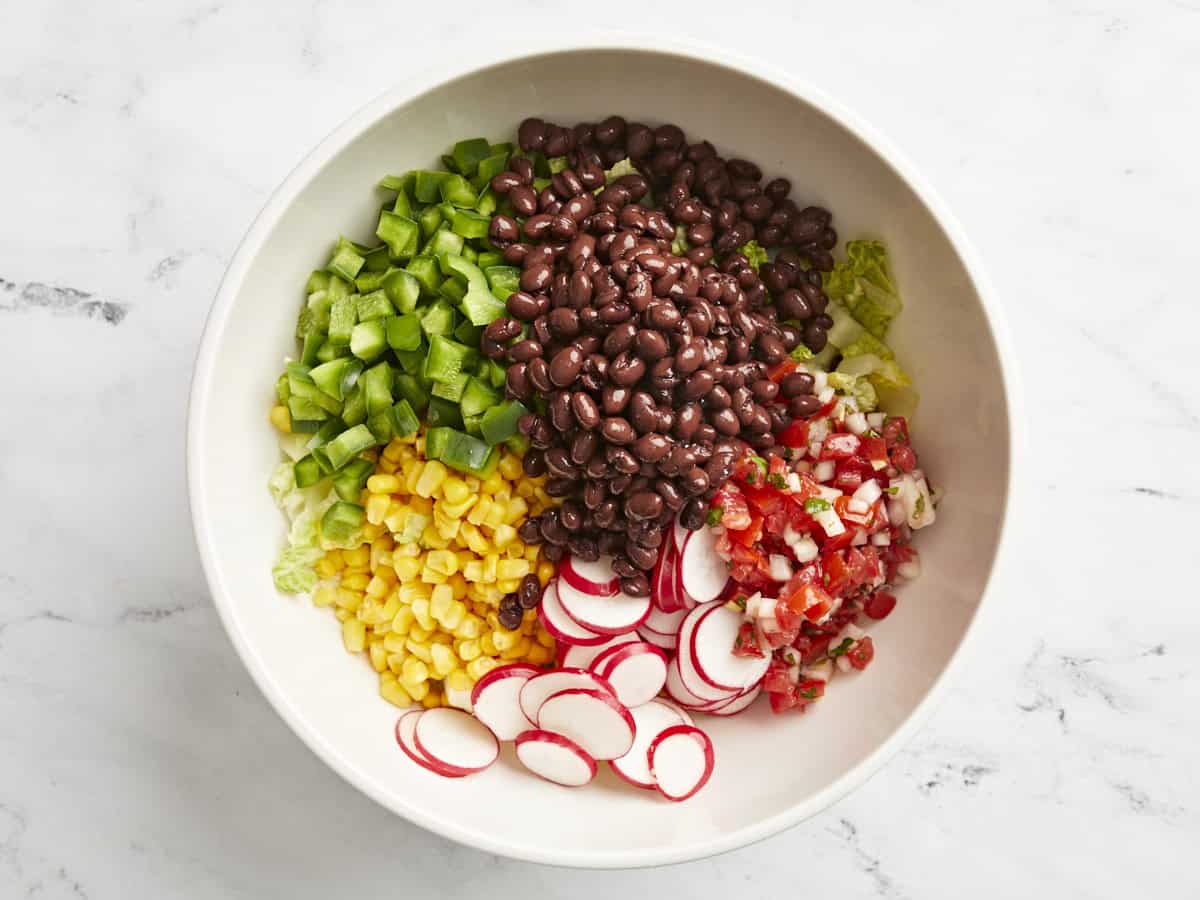 ingredients for santa fe salad in a white bowl