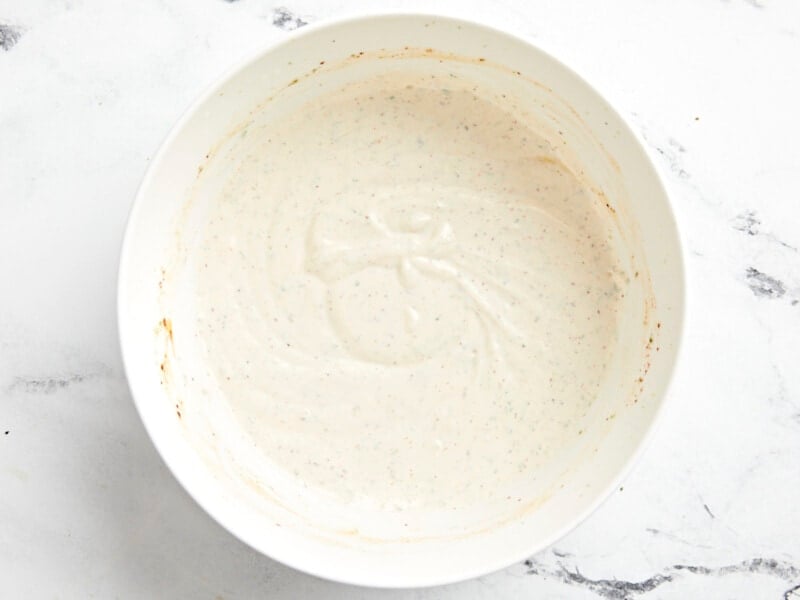 creamy white dressing in a white bowl.