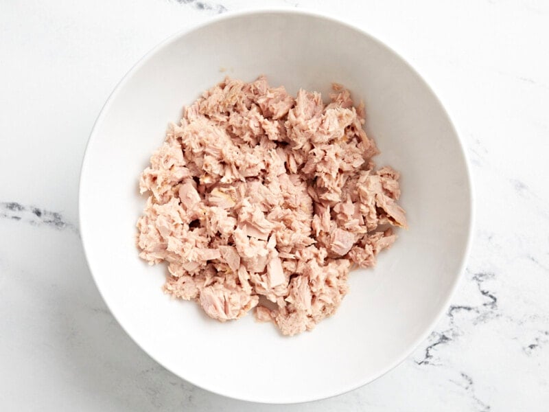 drained tuna in a white bowl.