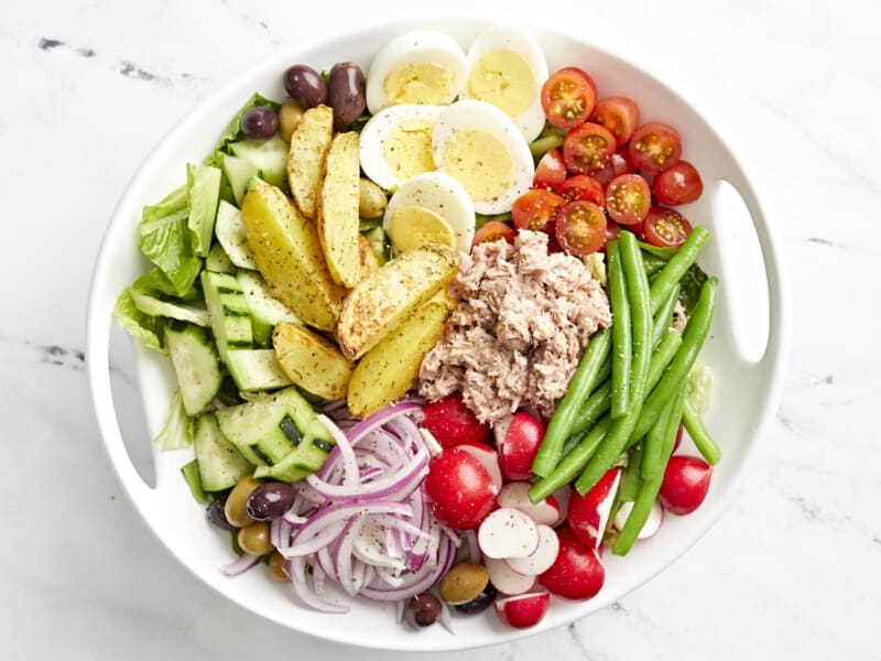 nicoise salad in a white bowl.