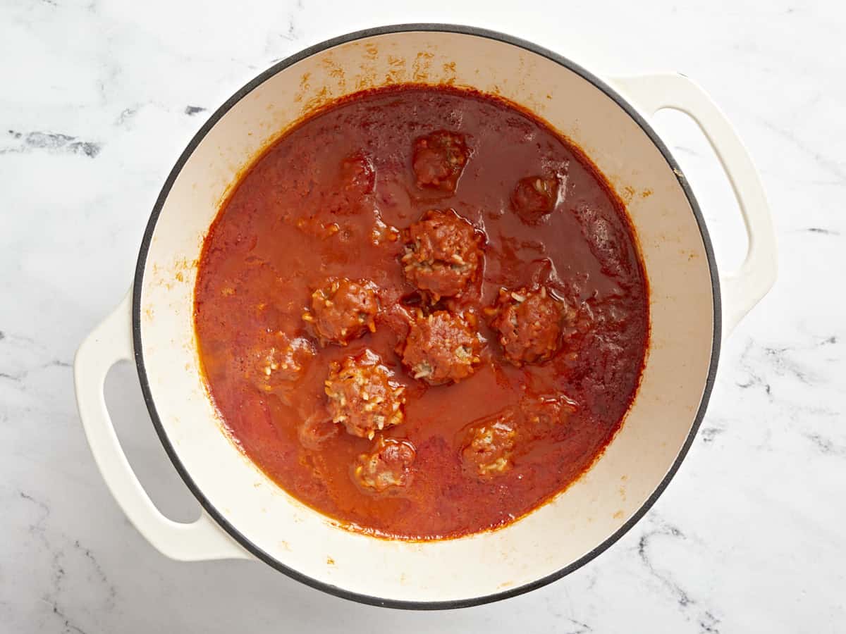 Cooked porcupine meatballs inside dutch oven.