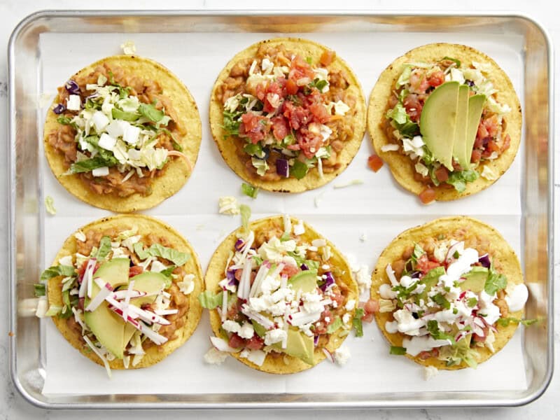 8 add all the toppings 1 by 1 to tostadas