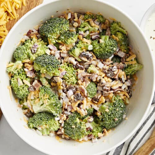 Top view of broccoli salad in a white bowl.