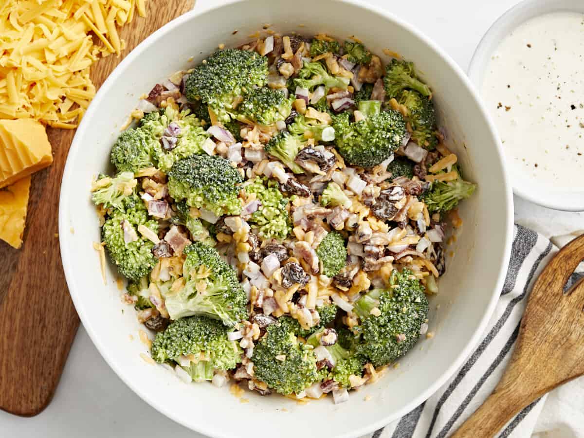 Top view of broccoli salad in a white bowl.