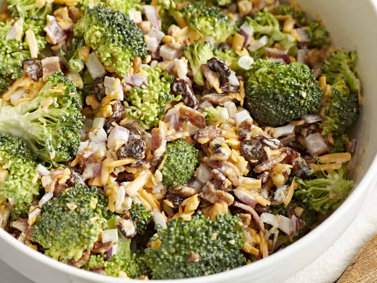 Close-up of broccoli salad on a white plate.