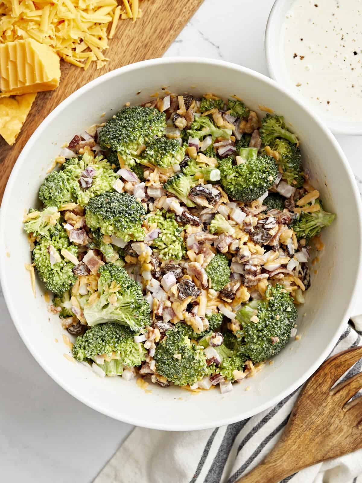 Top view of broccoli salad in a white bowl.