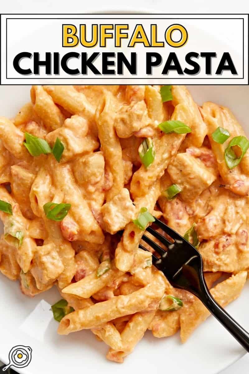 Close-up top view of a bowl of buffalo chicken noodles with a fork.