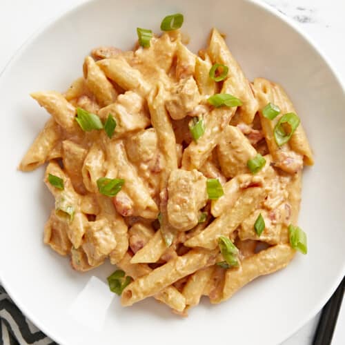 Top view of a bowl full of buffalo chicken noodles.