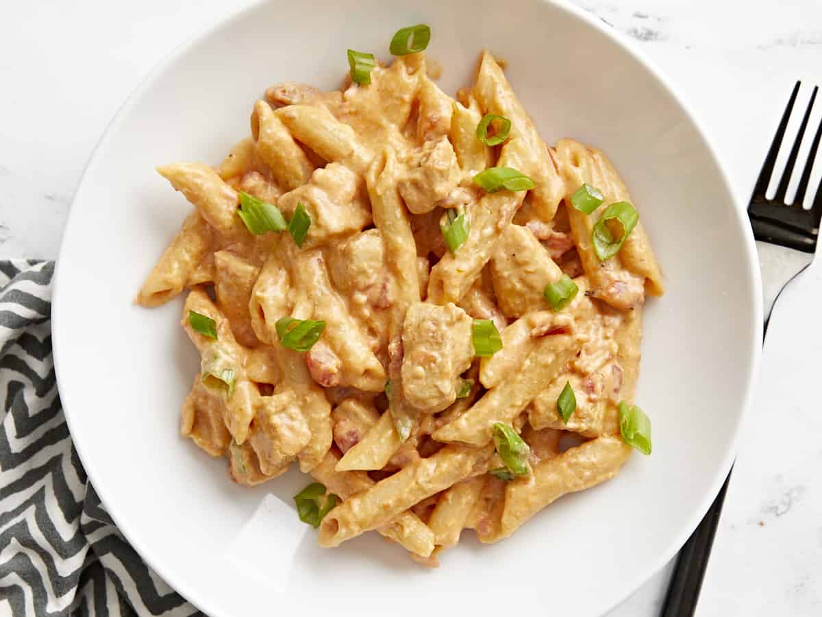 Top view of a bowl full of buffalo chicken noodles.