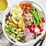 nicoise salad in a white bowl.