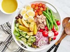 nicoise salad in a white bowl.
