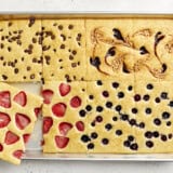 Overhead view of sheet pan pancakes cut into squares with one slice being lifted out.