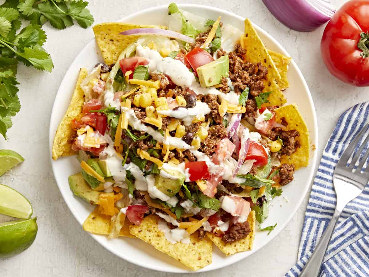 overhead view of a serving of taco salad on a white plate.