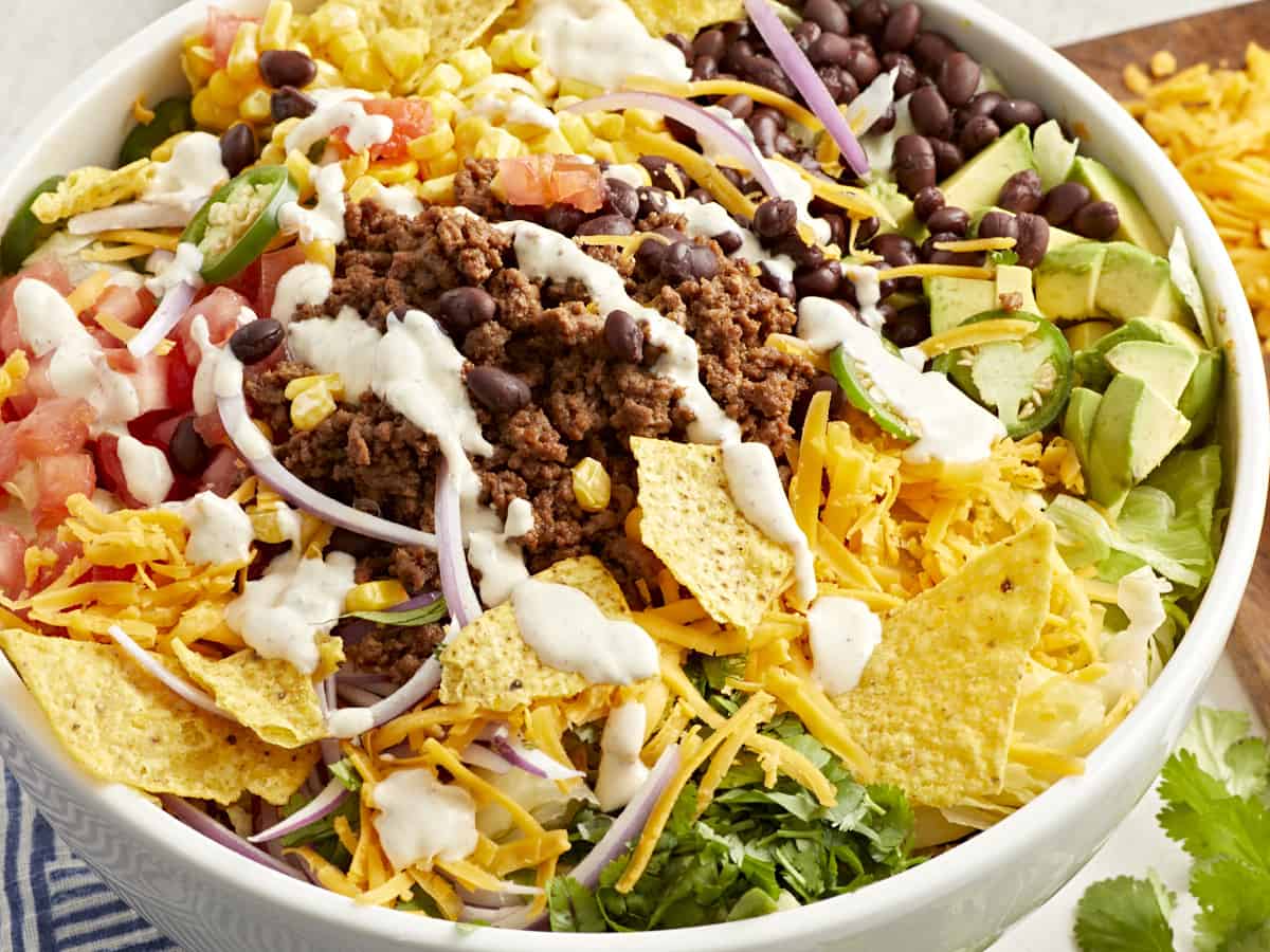 Three-quarter view of taco salad in a white bowl.