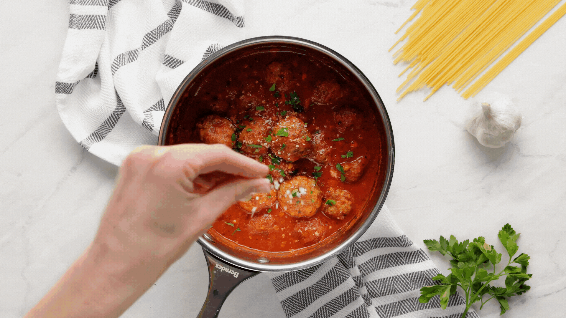 meatballs being served over pasta