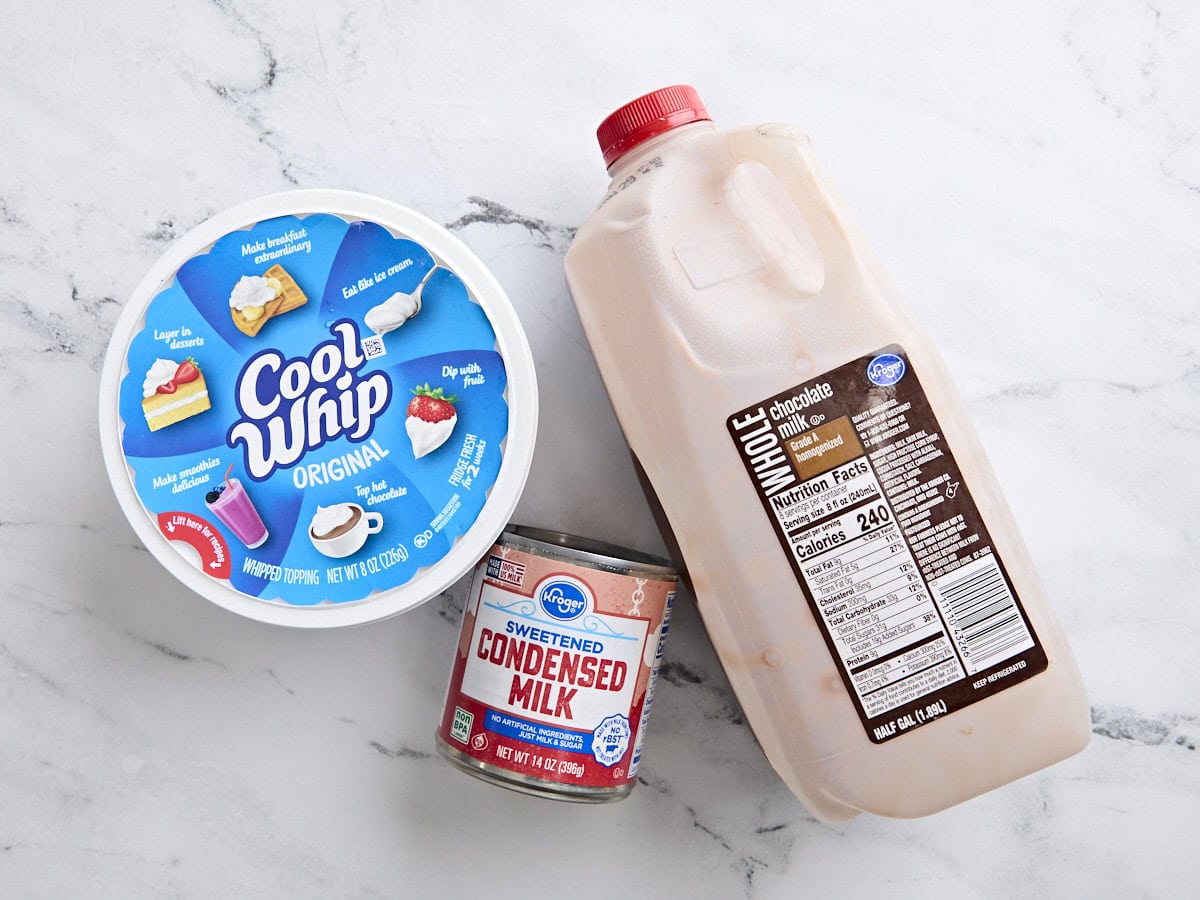 A bottle of chocolate milk, a can of sweetened condensed milk, and a tub of cool whip.