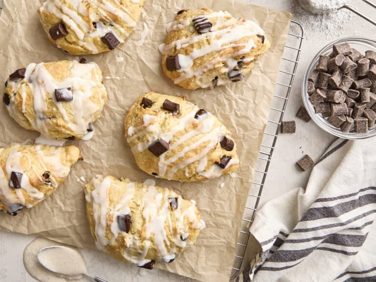 Overhead view of homemade chocolate chip sourdough scones on a parchment lined wire rack.