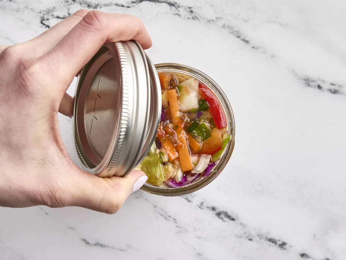 A jar of homemade kimchi after one day.