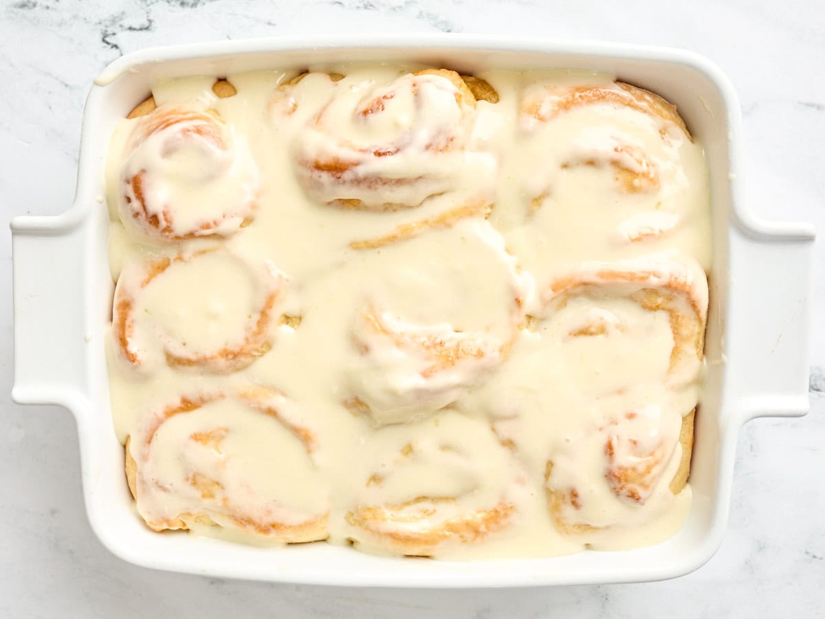 Finished orange rolls in a baking dish.