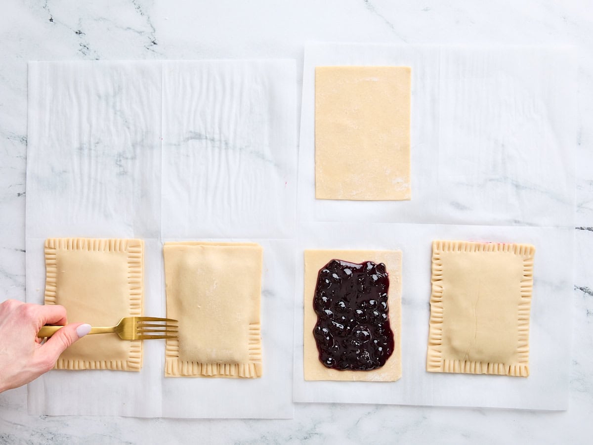 A fork crimping the edges of a homemade pop tart.