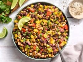 Overhead view of a bowl of cowboy caviar with a spoon.