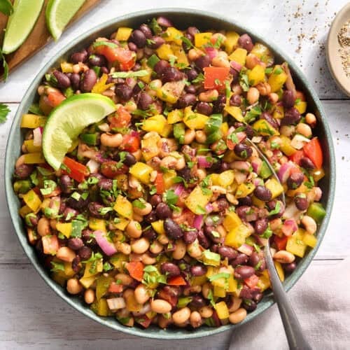 Overhead view of a bowl of cowboy caviar with a spoon.