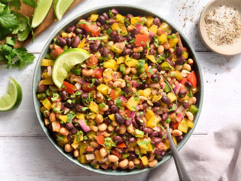 Overhead view of a bowl of cowboy caviar with a spoon.
