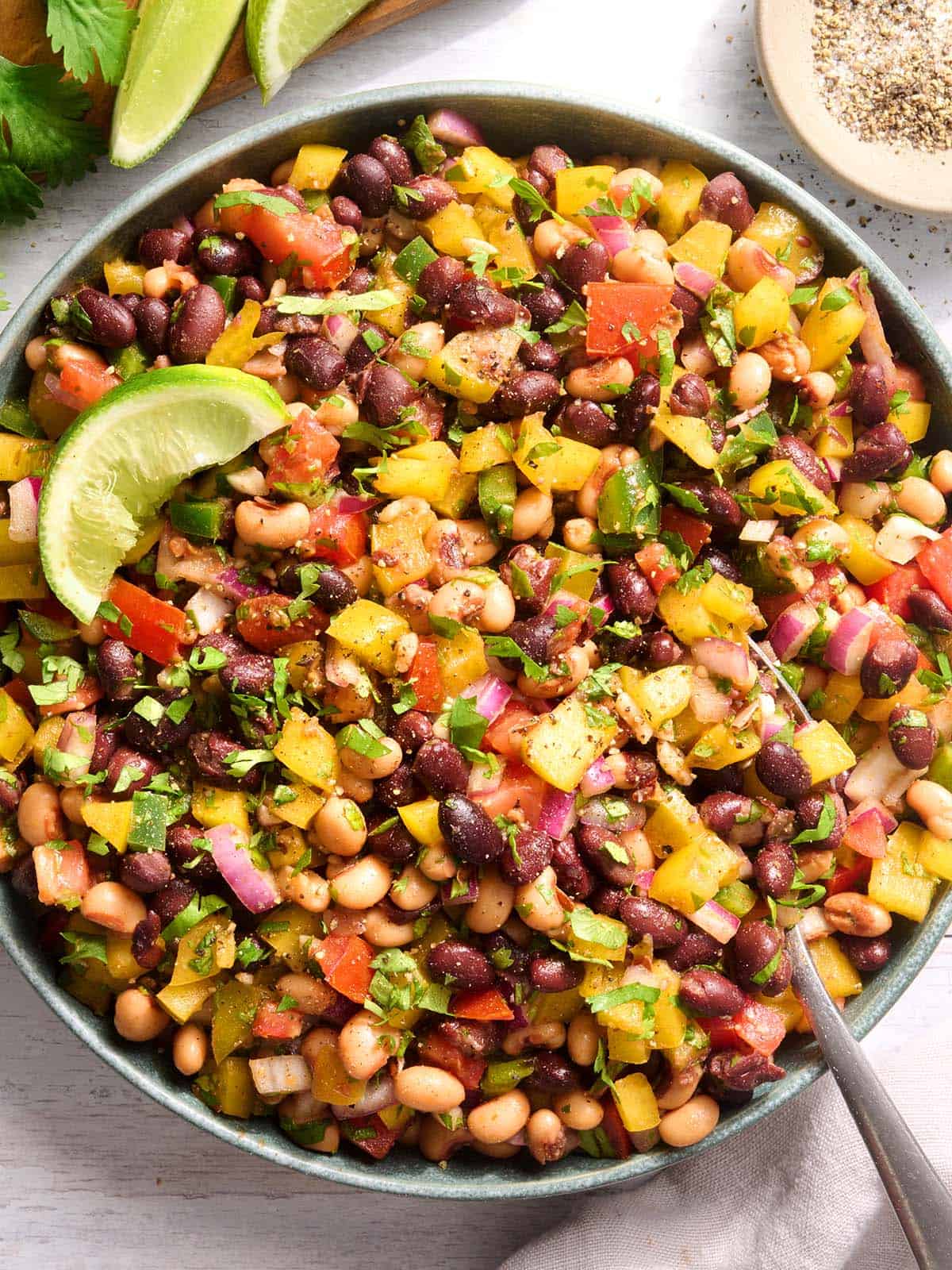 Overhead view of a bowl of cowboy caviar with a spoon.